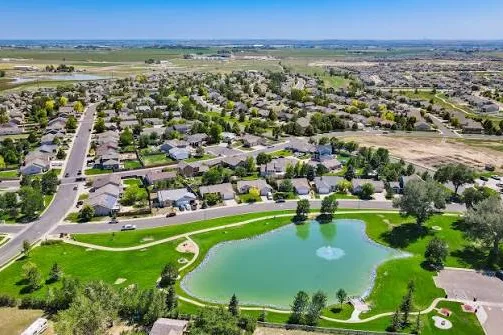 Aerial view of a pond park and homes in Severance, CO