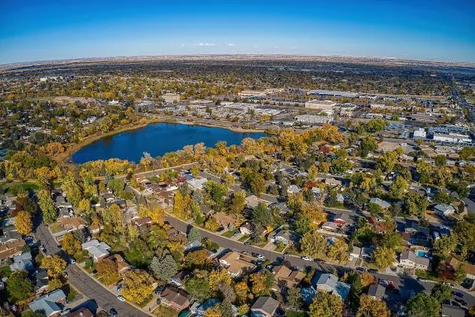 Aerial view of a lake and neighborhoods in Thornton, CO in autumn